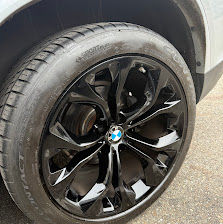 BMW rim refinished in gloss black — mirror-smooth finish, like new