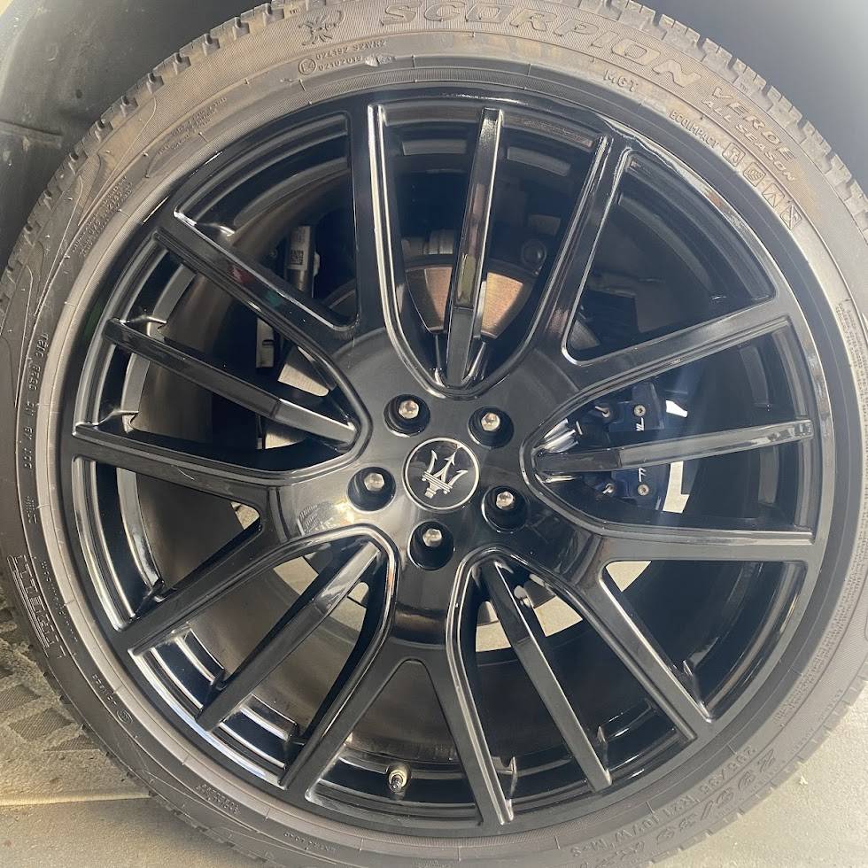 Maserati rim refinished in deep gloss black — showroom quality finish